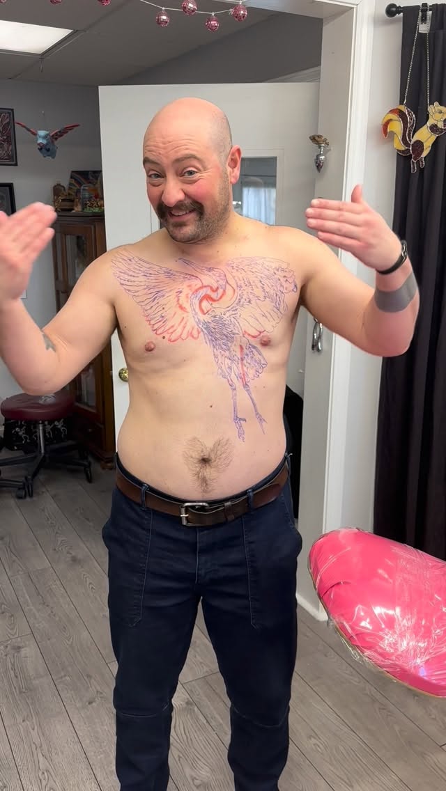Pink and purple crane chest tattoo
