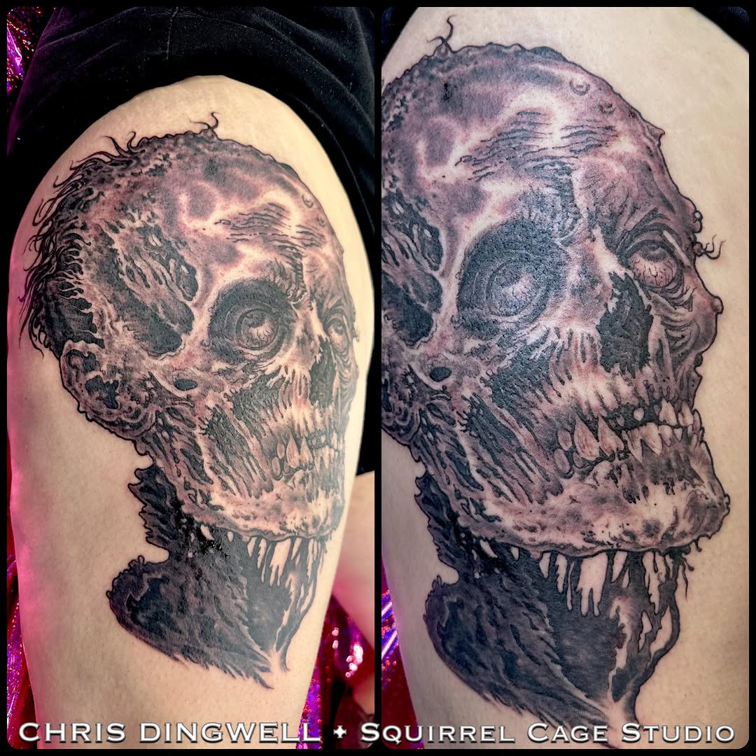 Zombie skull thigh tattoo, black-and-grey realism