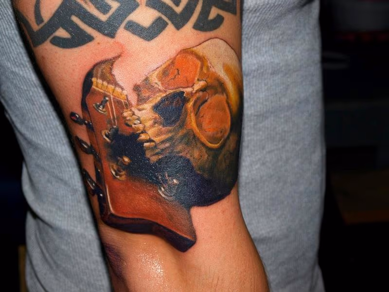 colr skull guitar tattoo