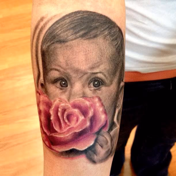 baby holding a rose portrait