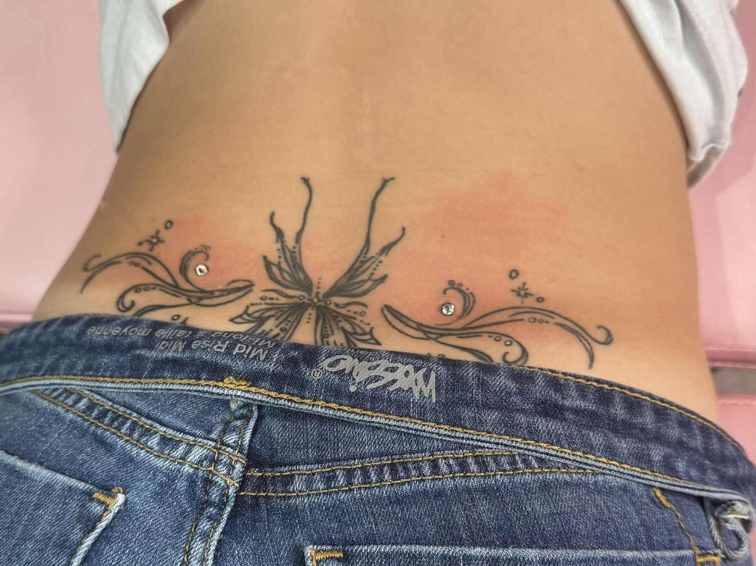 Back Dermal piercings adorning her tattoo