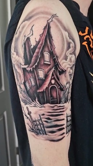 Haunted house tattoo on upper arm, black and grey