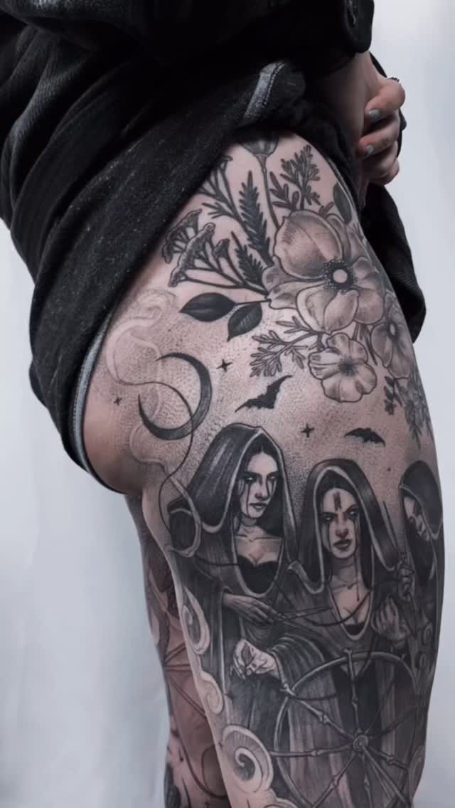 Black-and-grey leg sleeve with floral and portrait motifs