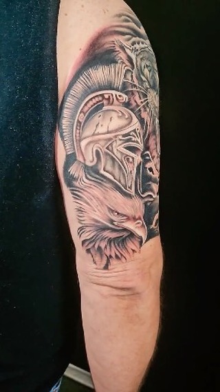 Black-and-grey warrior portrait sleeve tattoo, bicep