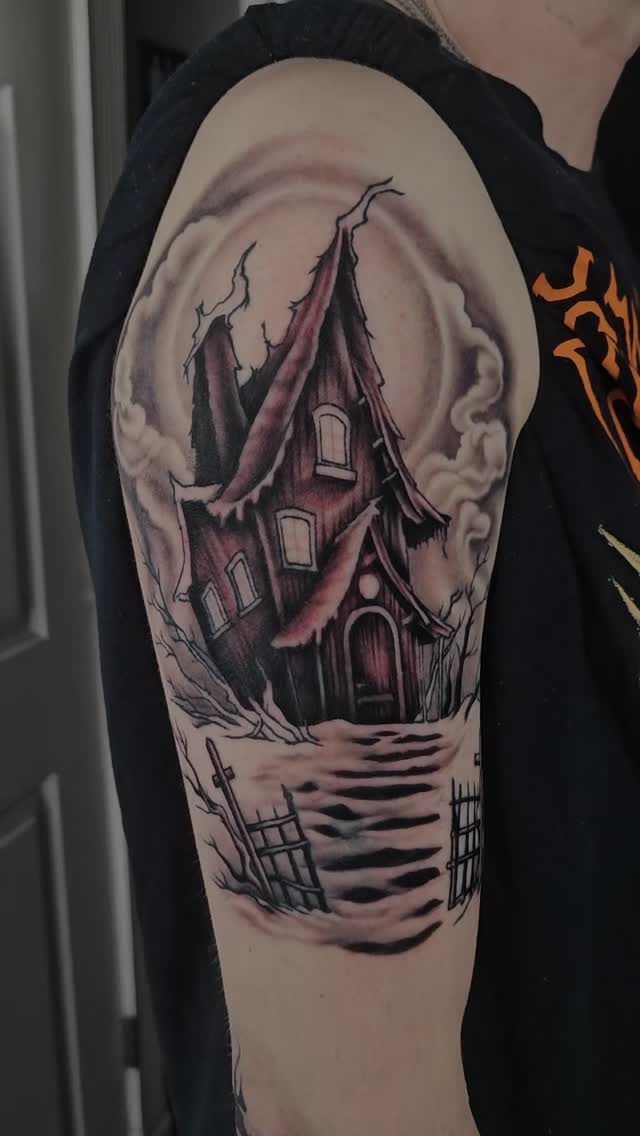 Haunted house sleeve tattoo with graveyard detail