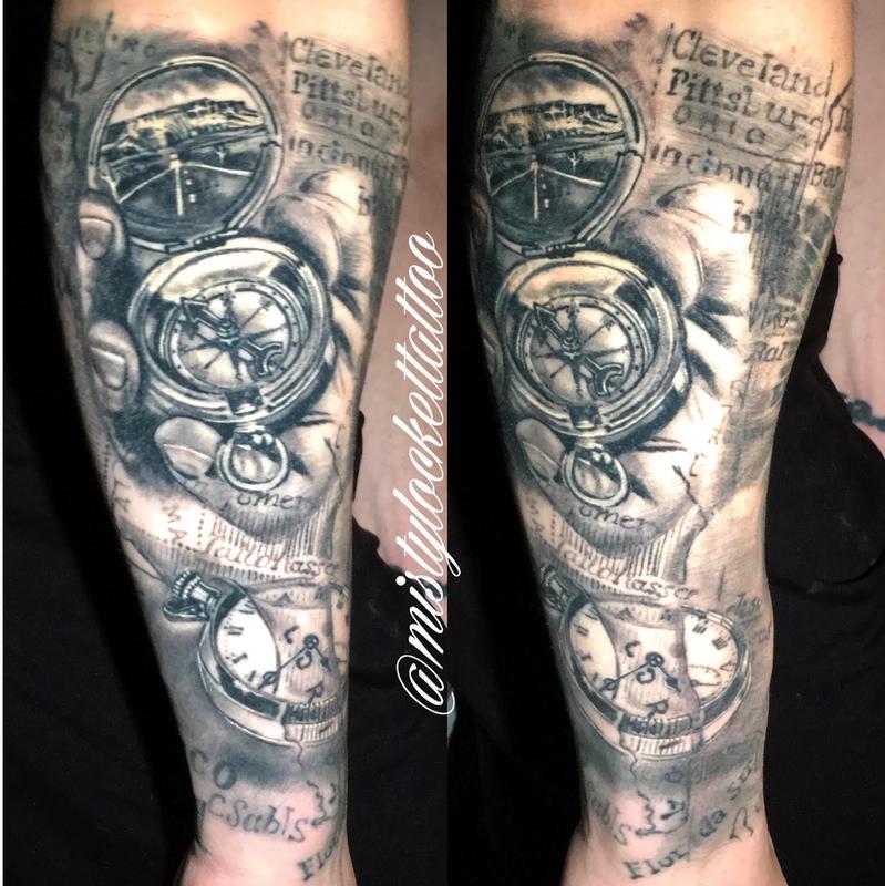 Black and grey watch, compass, map sleeve