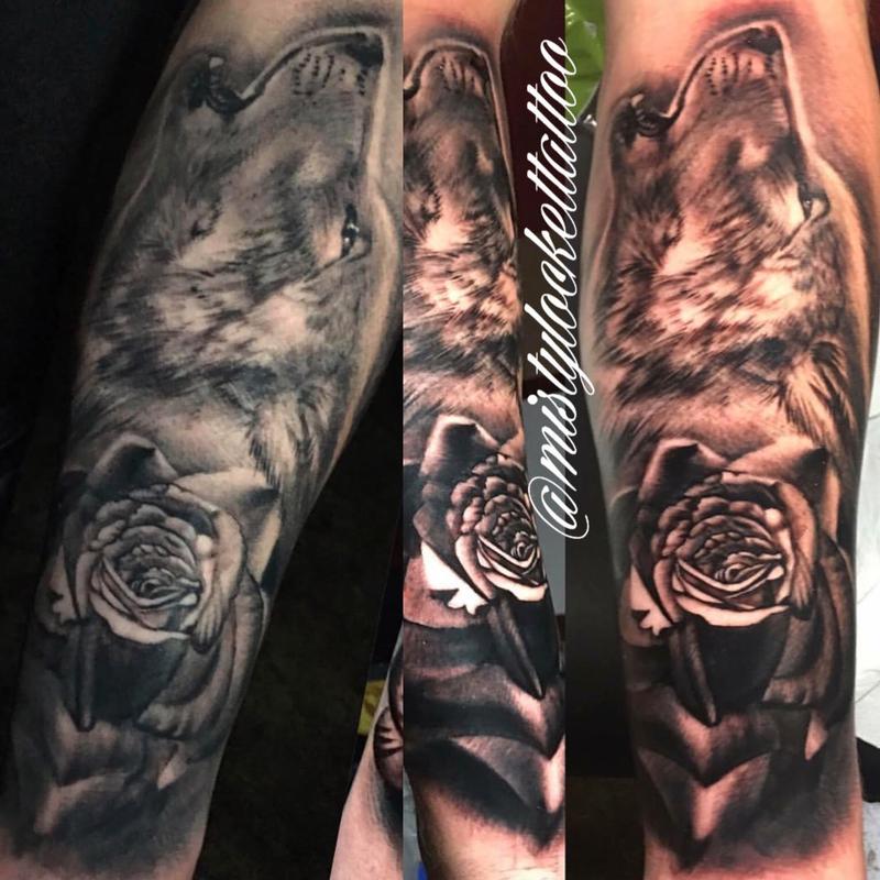 Black and grey wolf with rose