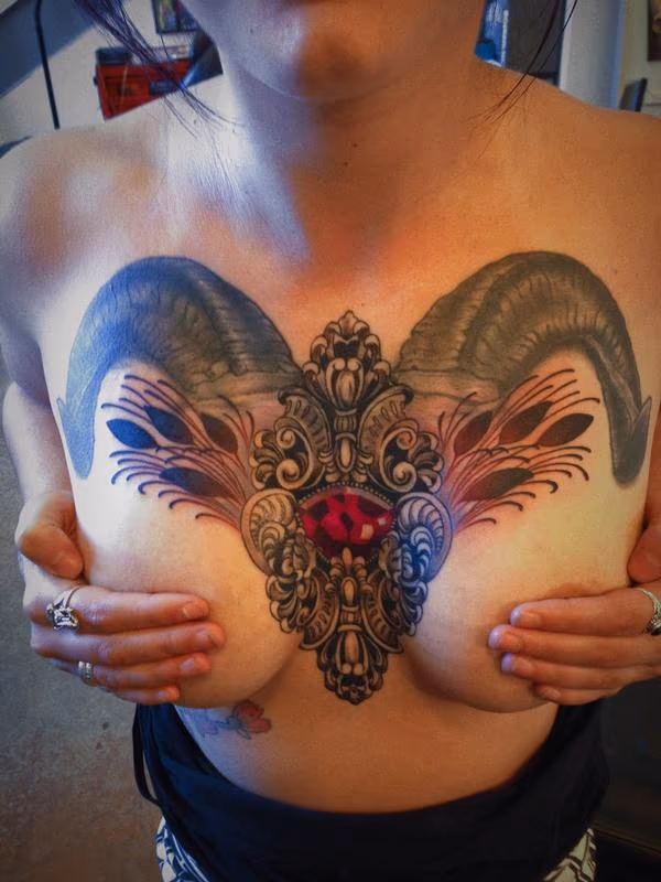 ornate gem with horns tattoo