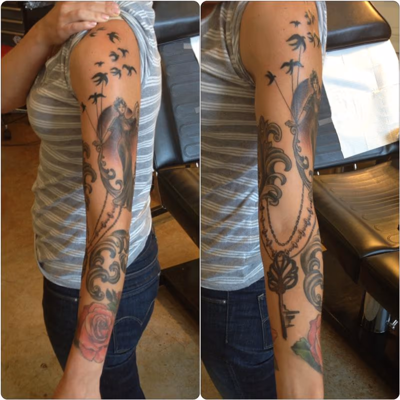 Feminine ornate sleeve tattoo