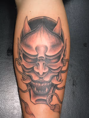Asian mask tattoo