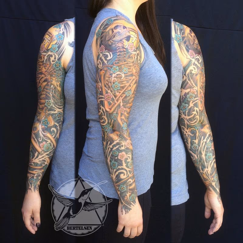 Full sleeve skeleton and forget me not flowers