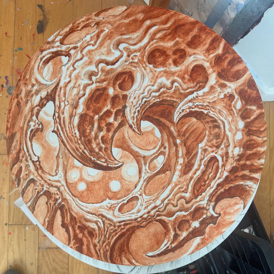 Biomechanical sienna underpainting on circular panel
