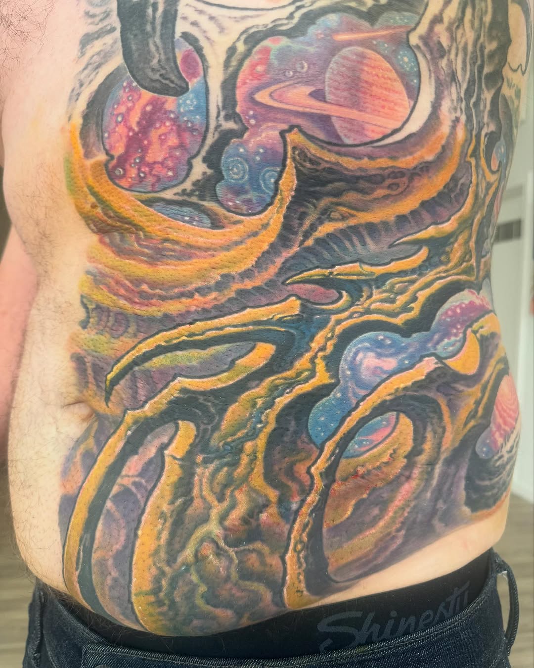 Biomechanical space tattoo on torso, color