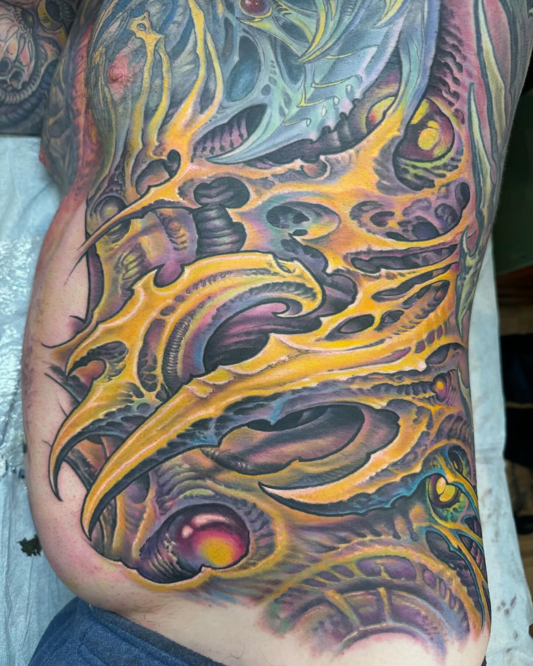 Color biomechanical torso tattoo in progress