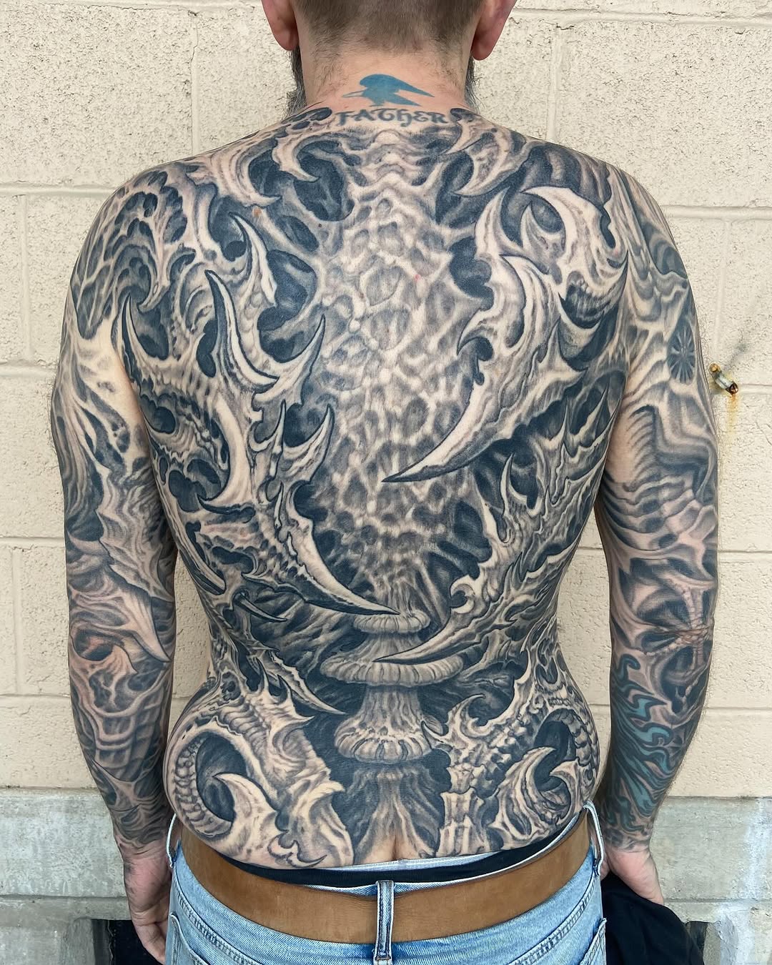 Black-and-grey biomechanical backpiece