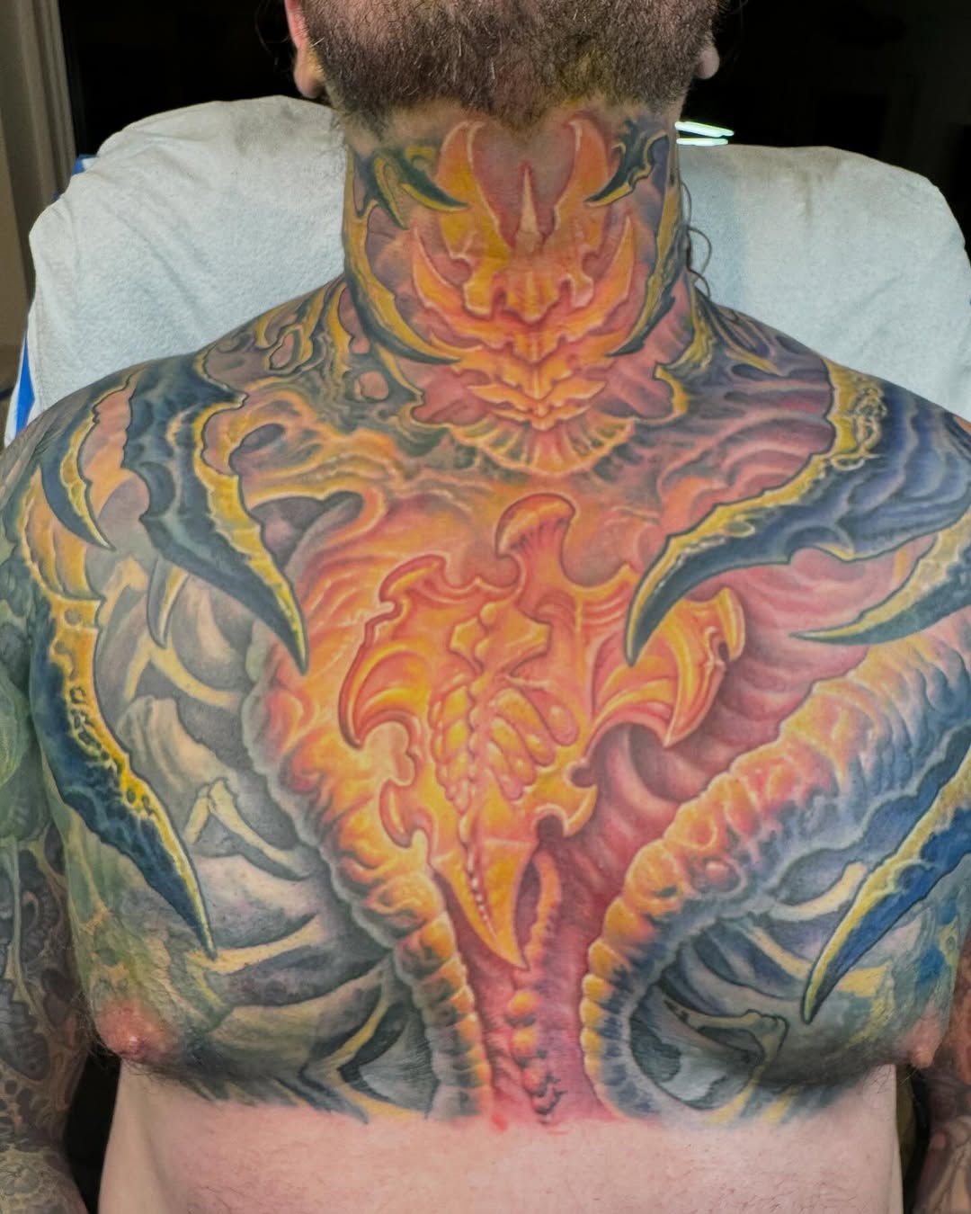 Biomech chest and neck tattoo in color