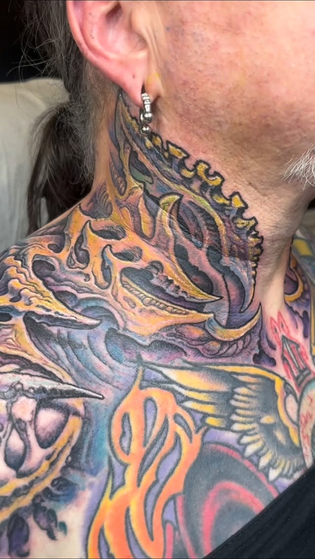 Biomechanical neck and chest tattoo in color