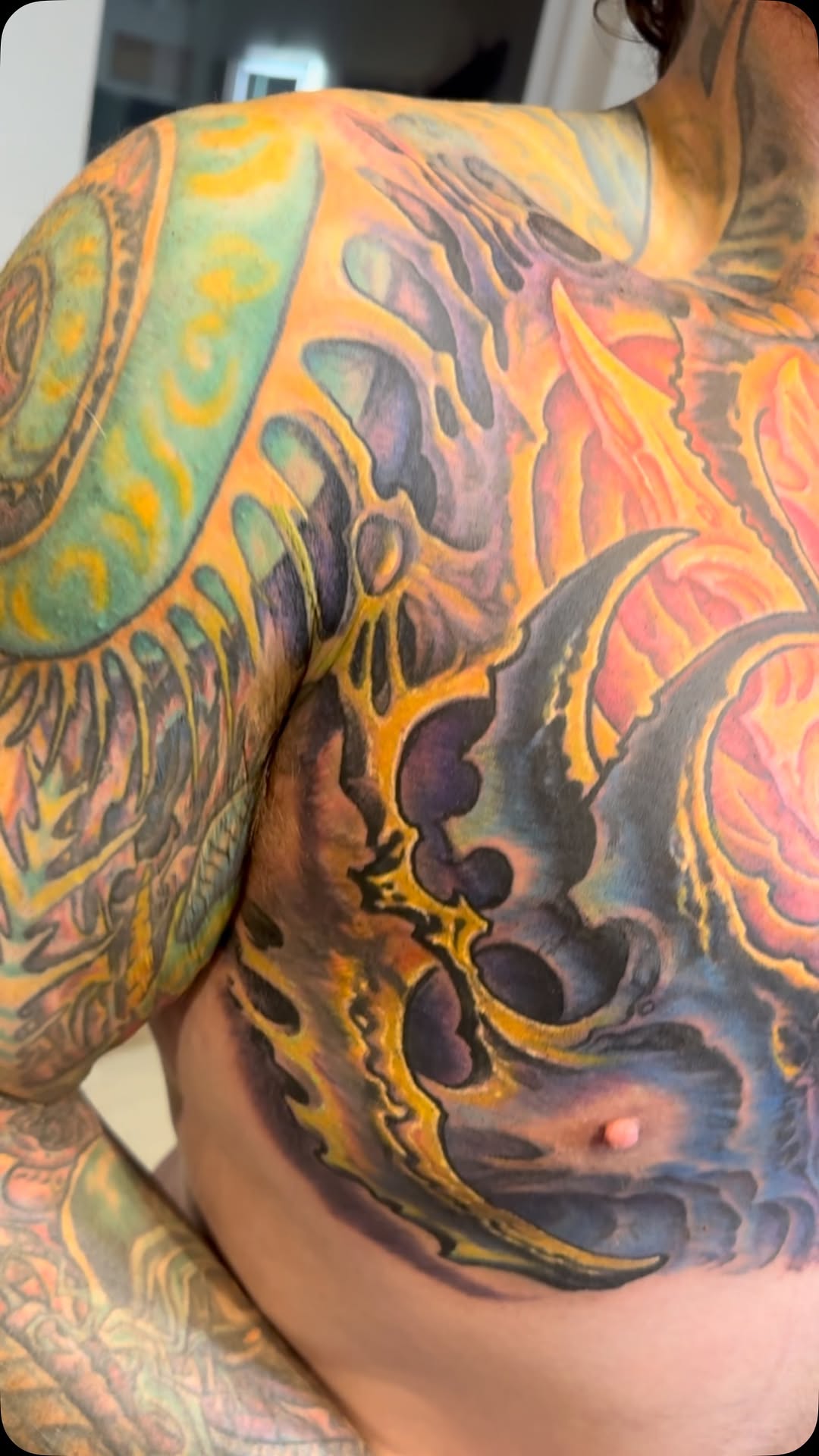 Biomechanical color chest and stomach tattoo