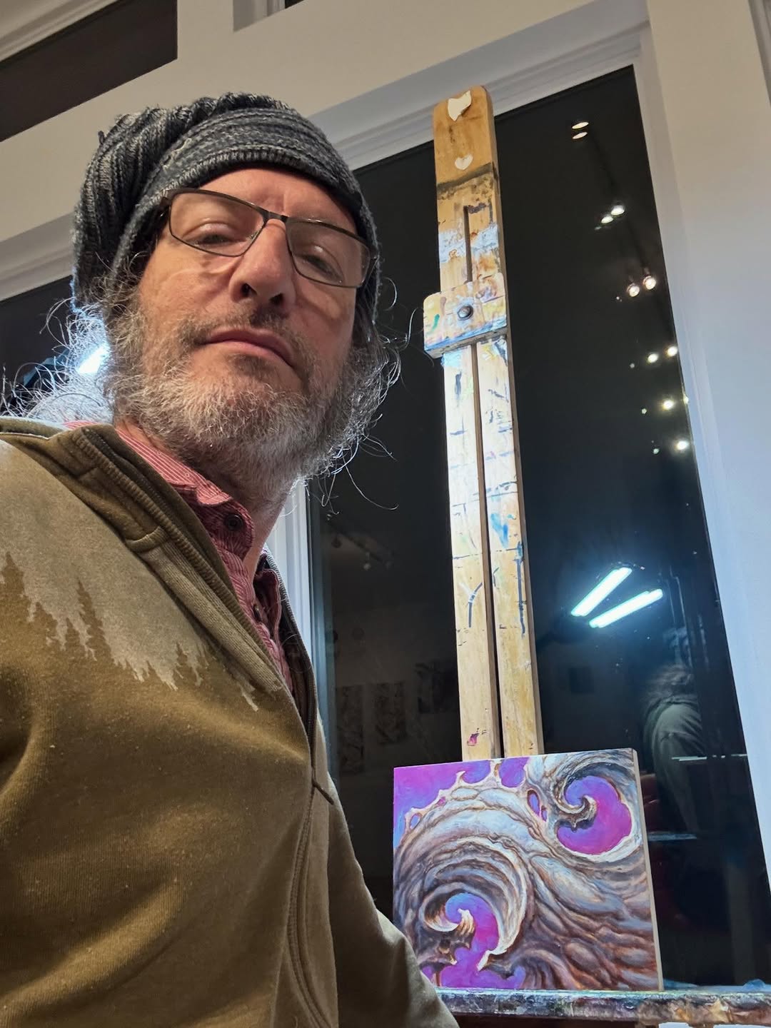 Artist studio selfie with abstract wave painting