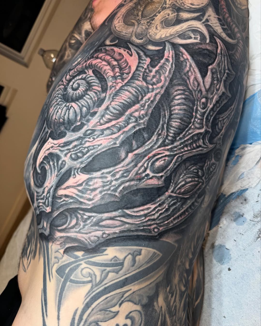 Biomechanical rib and shoulder coverup, black-and-grey