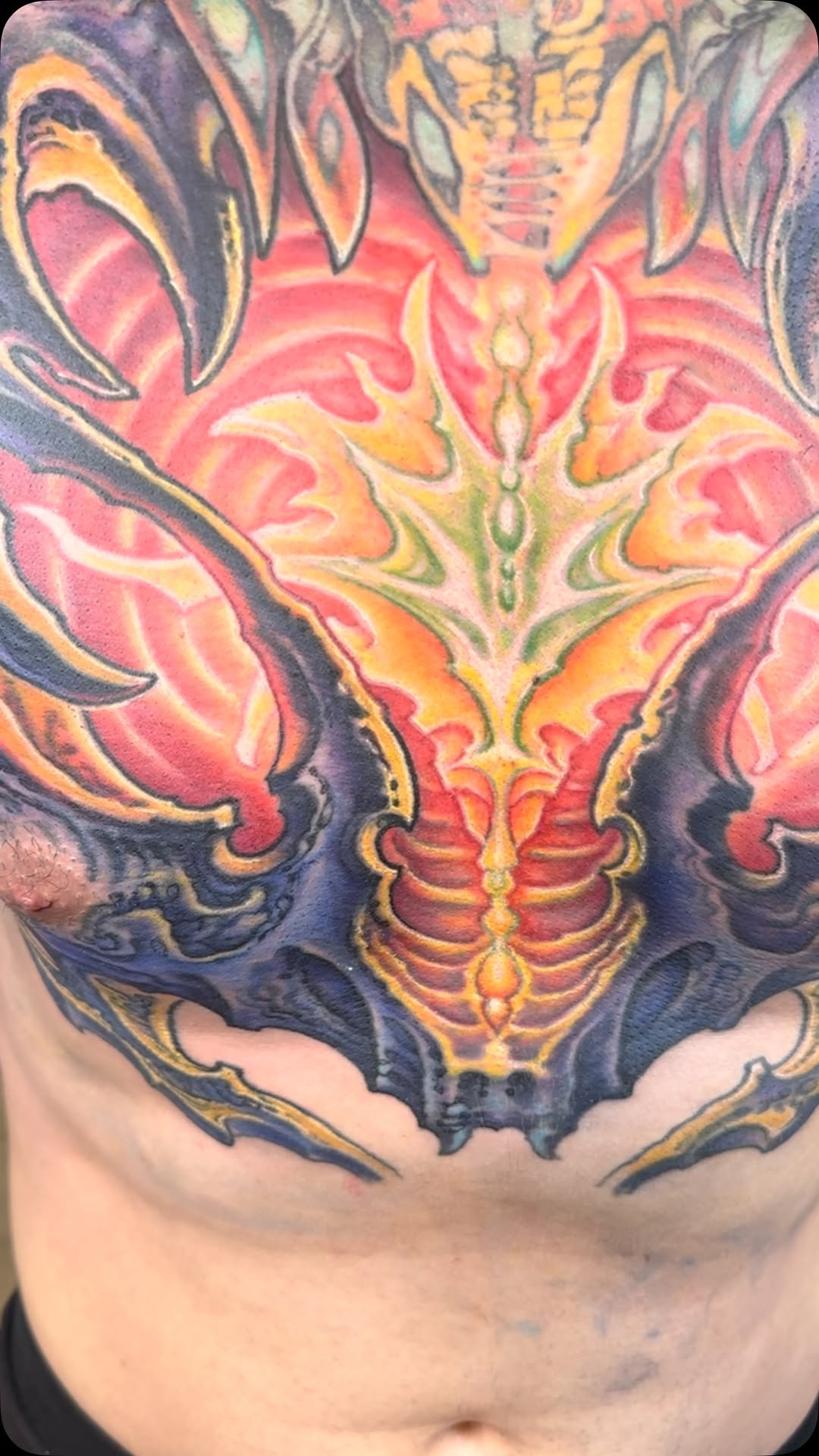 Biomechanical chest piece in red and orange