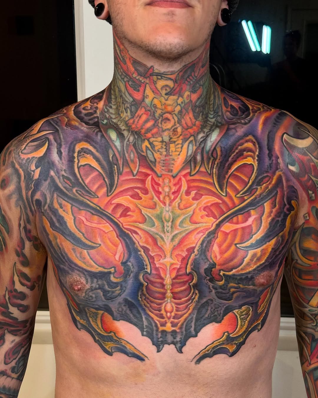 Biomechanical color chest and neck tattoo