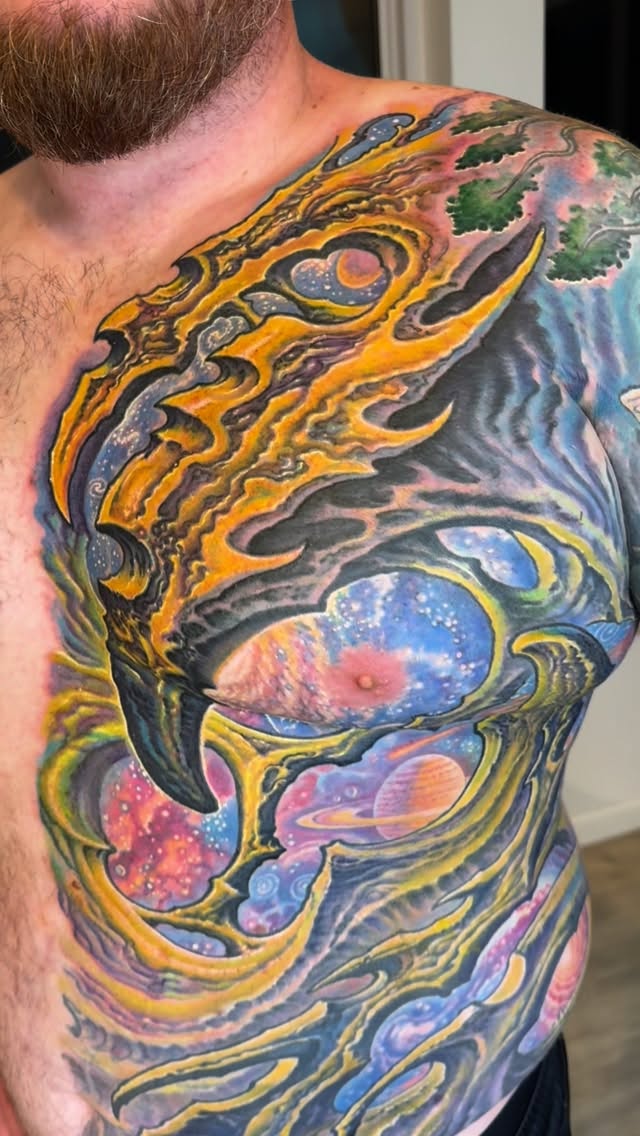Biomechanical cosmic chest and ribs tattoo in color