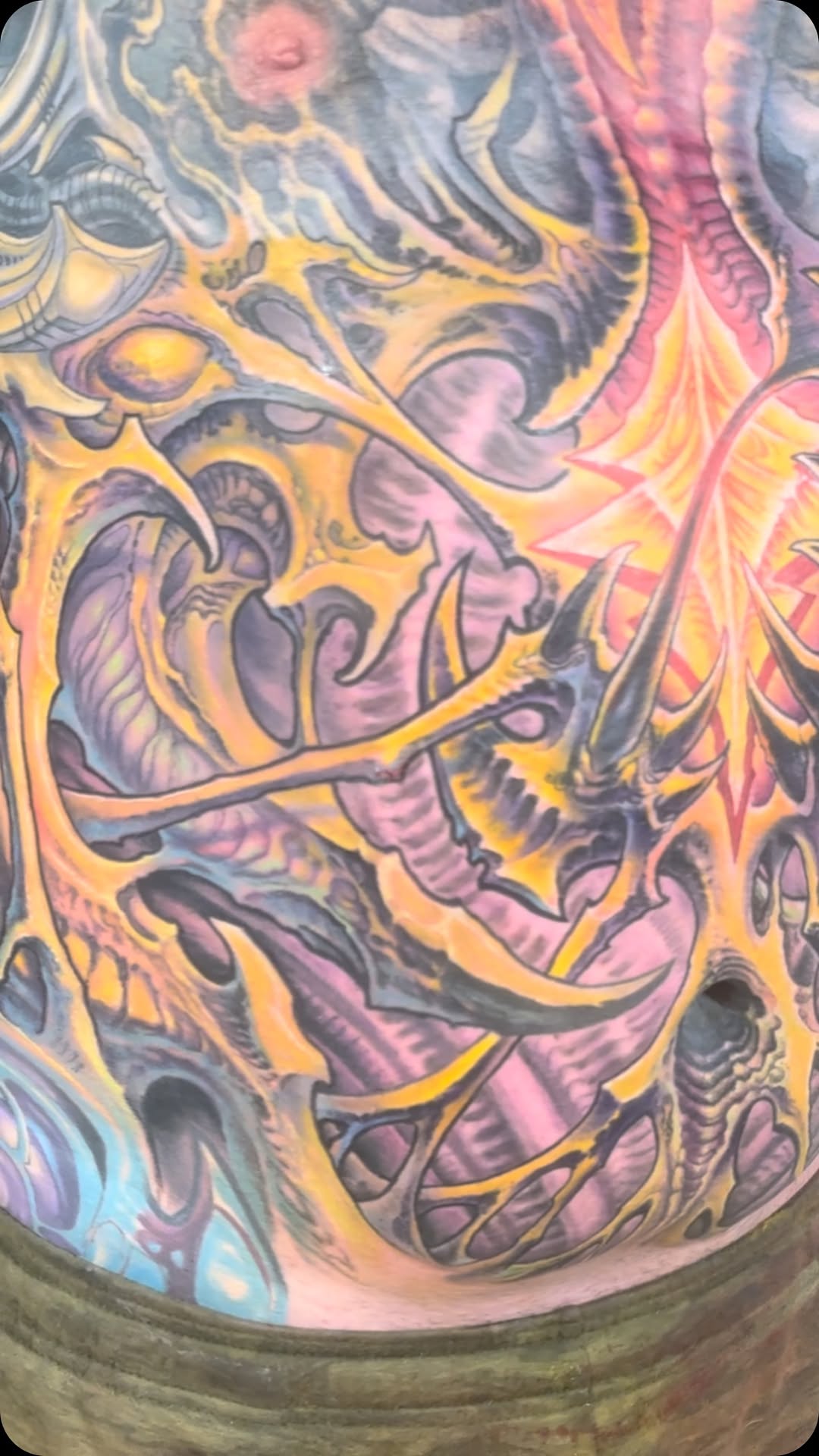 Biomech color collab tattoo on chest and stomach