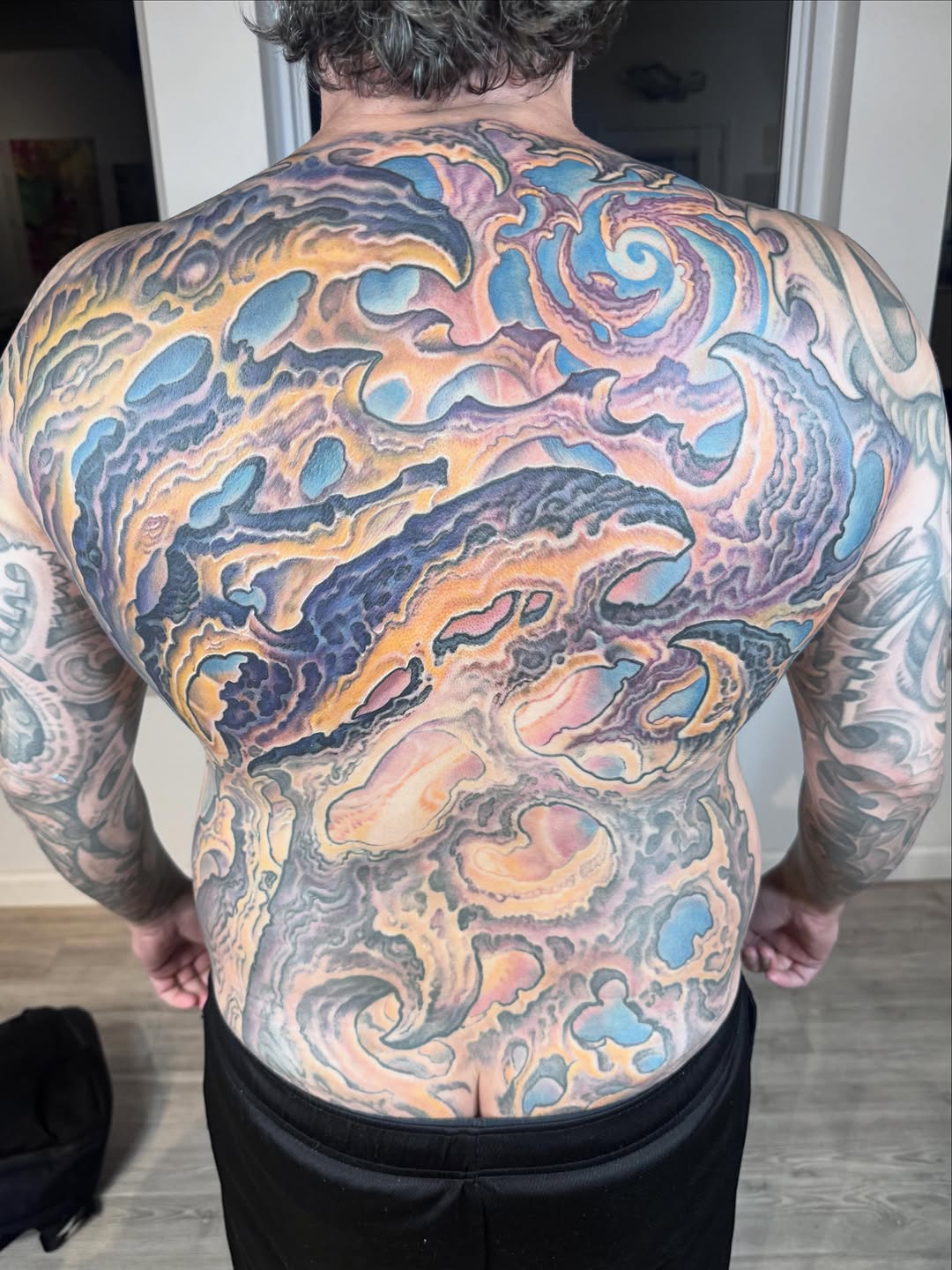 Ornamental back piece in color, abstract swirls