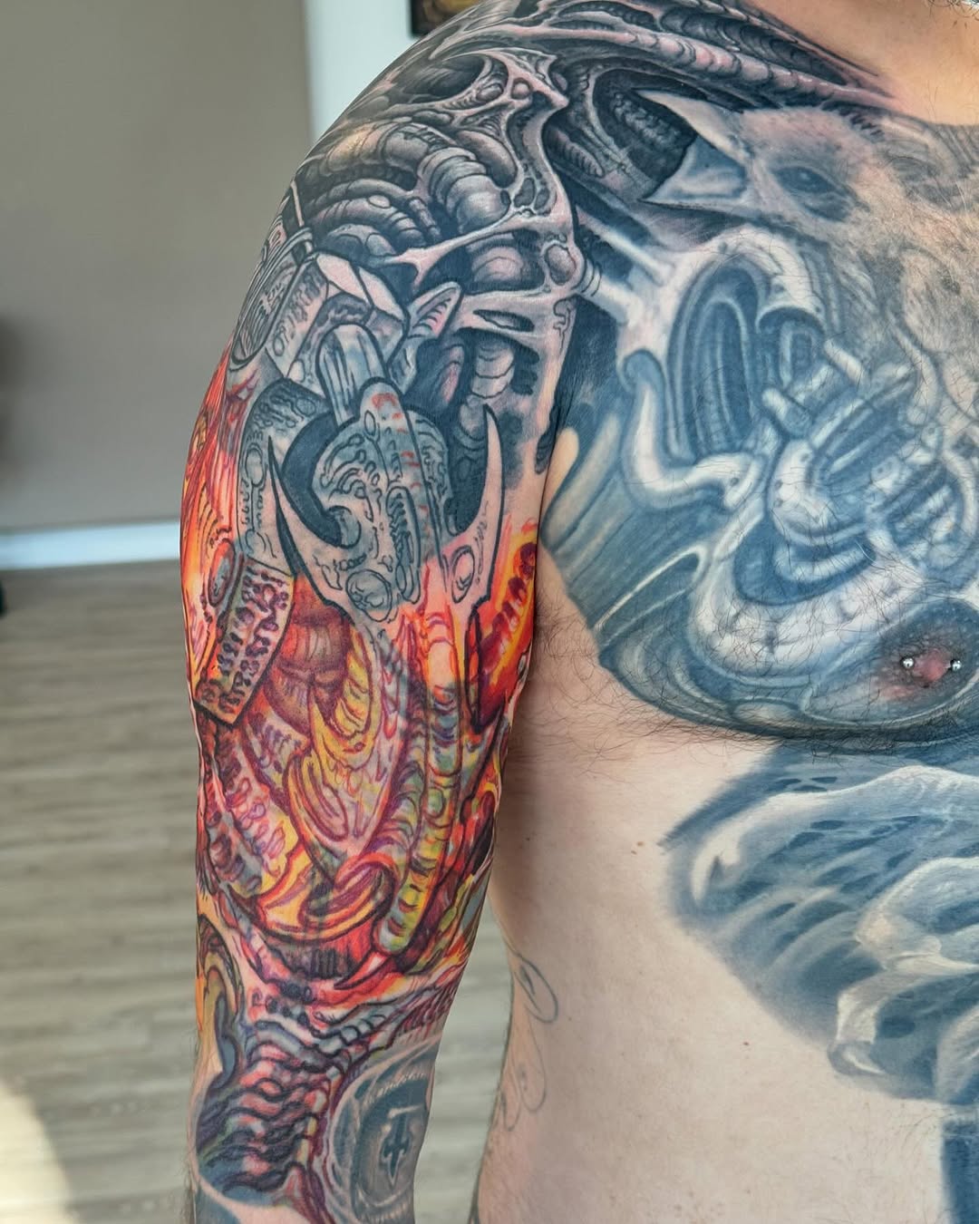 Biomechanical sleeve and chest tattoo in color