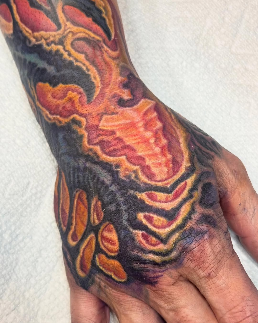 Biomechanical hand and wrist tattoo in color