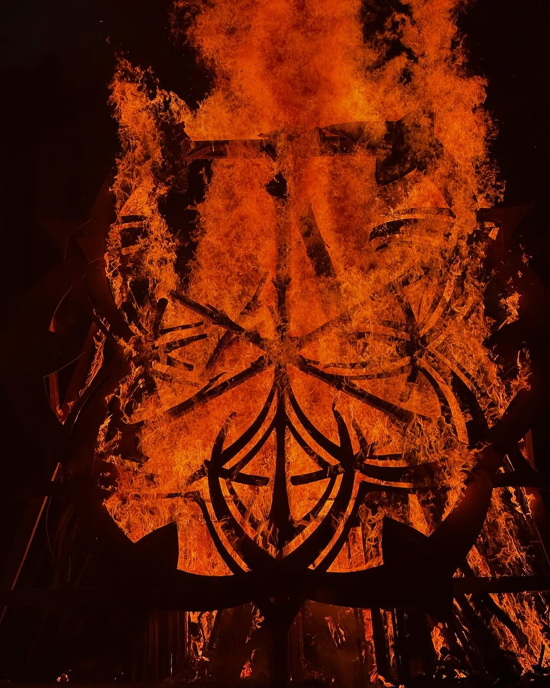 Burning steel mandala sculpture at night