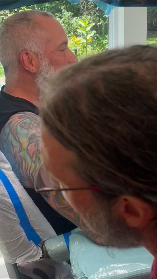 Colorful coverup tattoo session on shoulder