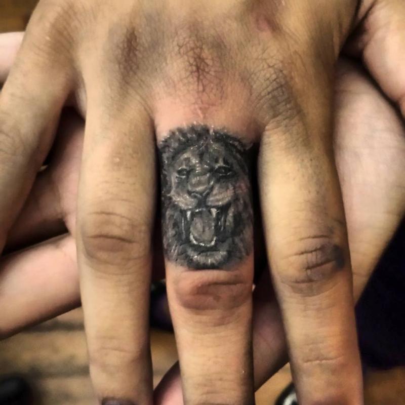 lion finger tattoo