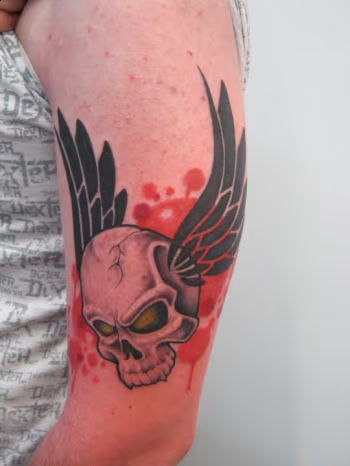 Custom flying skull tattoo