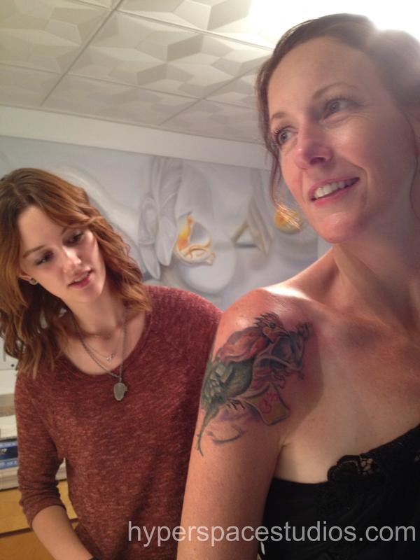 Mother and daughter checking out tattoo