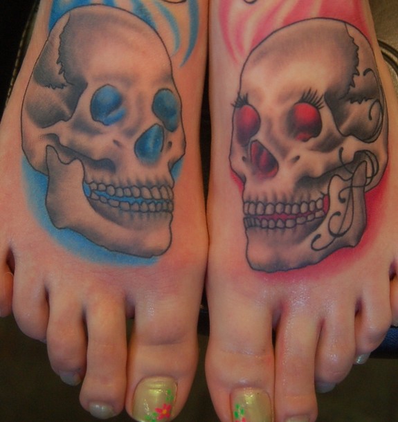 This is a pair of black and grey skulls on the foot with blue and pink backgrounds