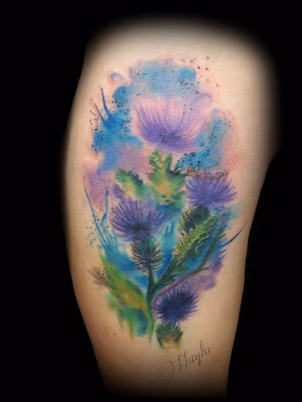 Thistle blossom watercolor style tattoo