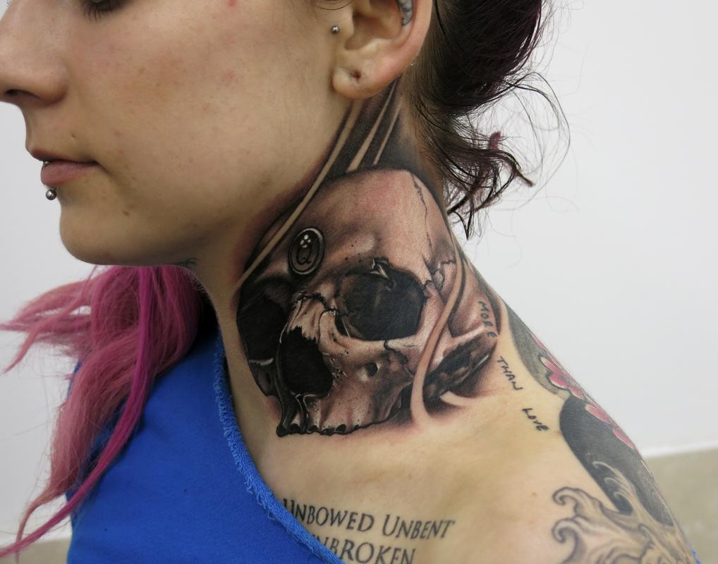 Skull neck tattoo
