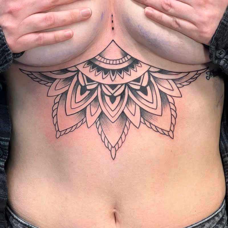 Intricate line work mandala fan tattoo