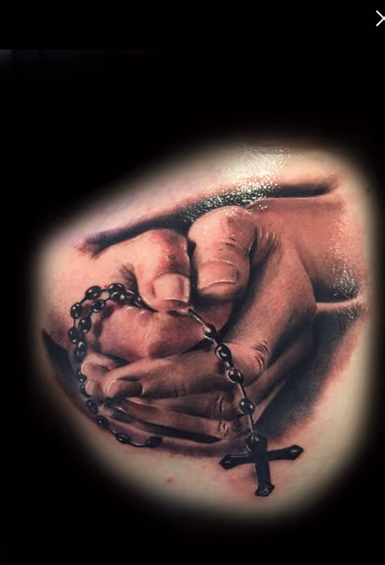 Hands holding rosary
