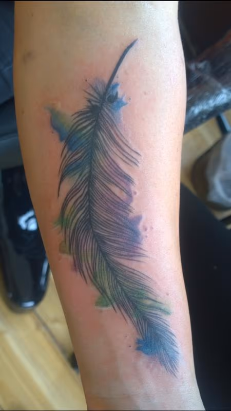 Feminine Watercolor Feather Tattoo