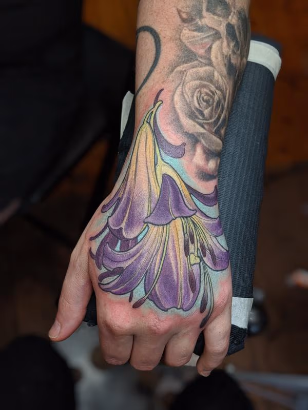 Color flower hand tattoo