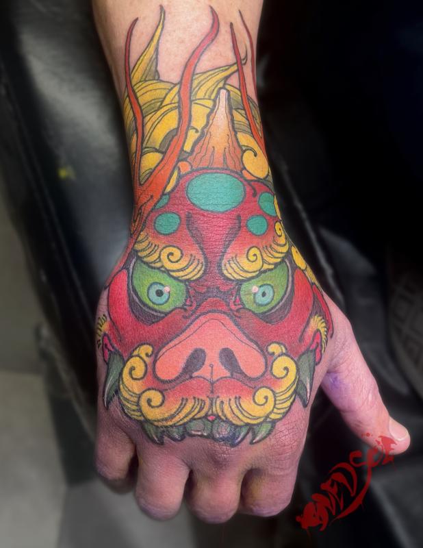Foo dog hand tattoo
