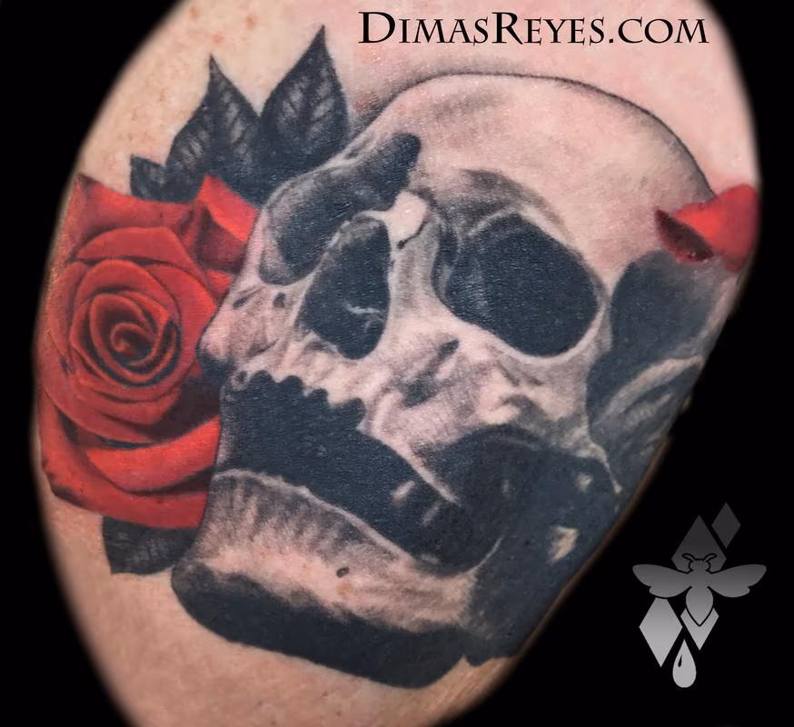 Black and grey skull with rose tattoo
