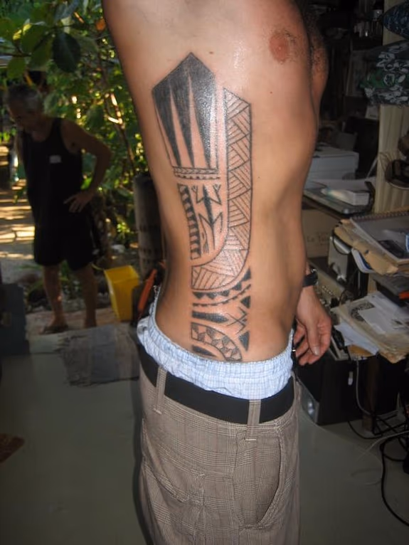 Traditional blackwork side tattoo