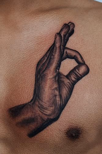 Hand sign tattoo