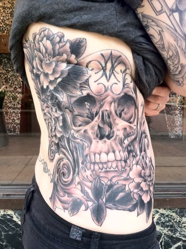Skull and Flowers Ribs Tattoo