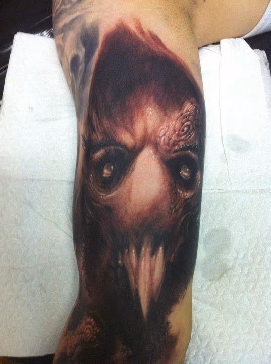 Evil face tattoo