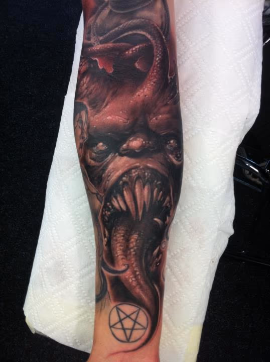 evil forearm half sleeve tattoo